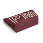 Burgundy monogram personalized cosmetic bag lying on its side