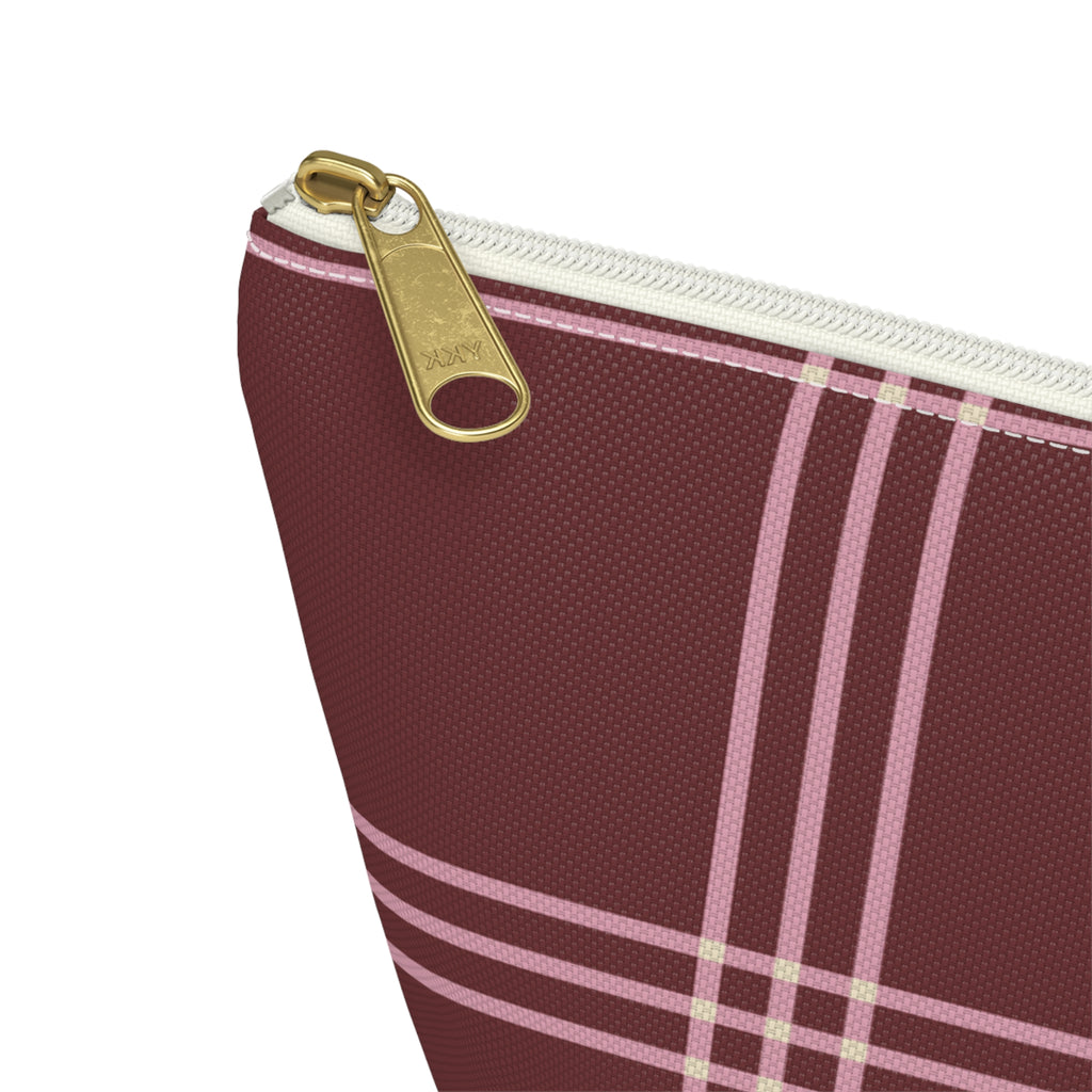 Close-up of the gold zipper pull on the burgundy pink plaid makeup bag