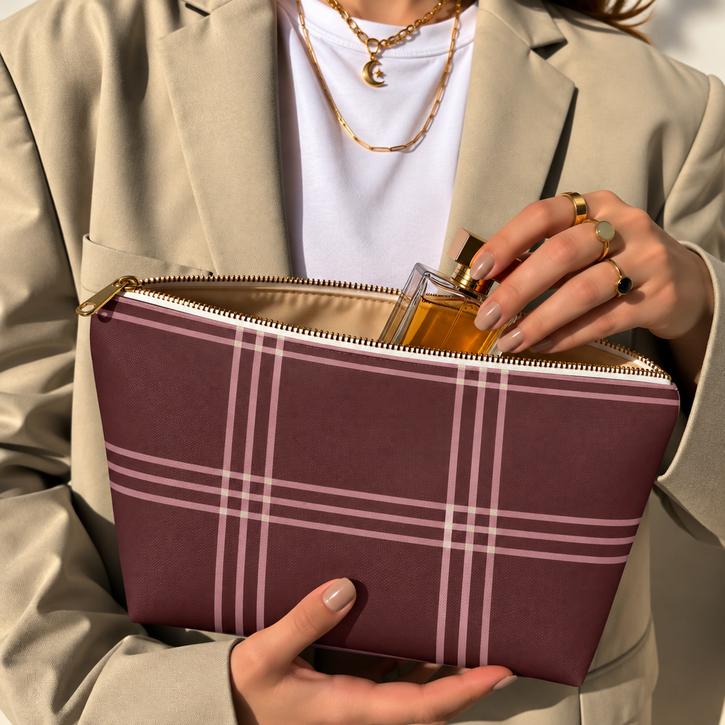 Model in a beige blazer taking a product out of the open burgundy pink plaid makeup bag