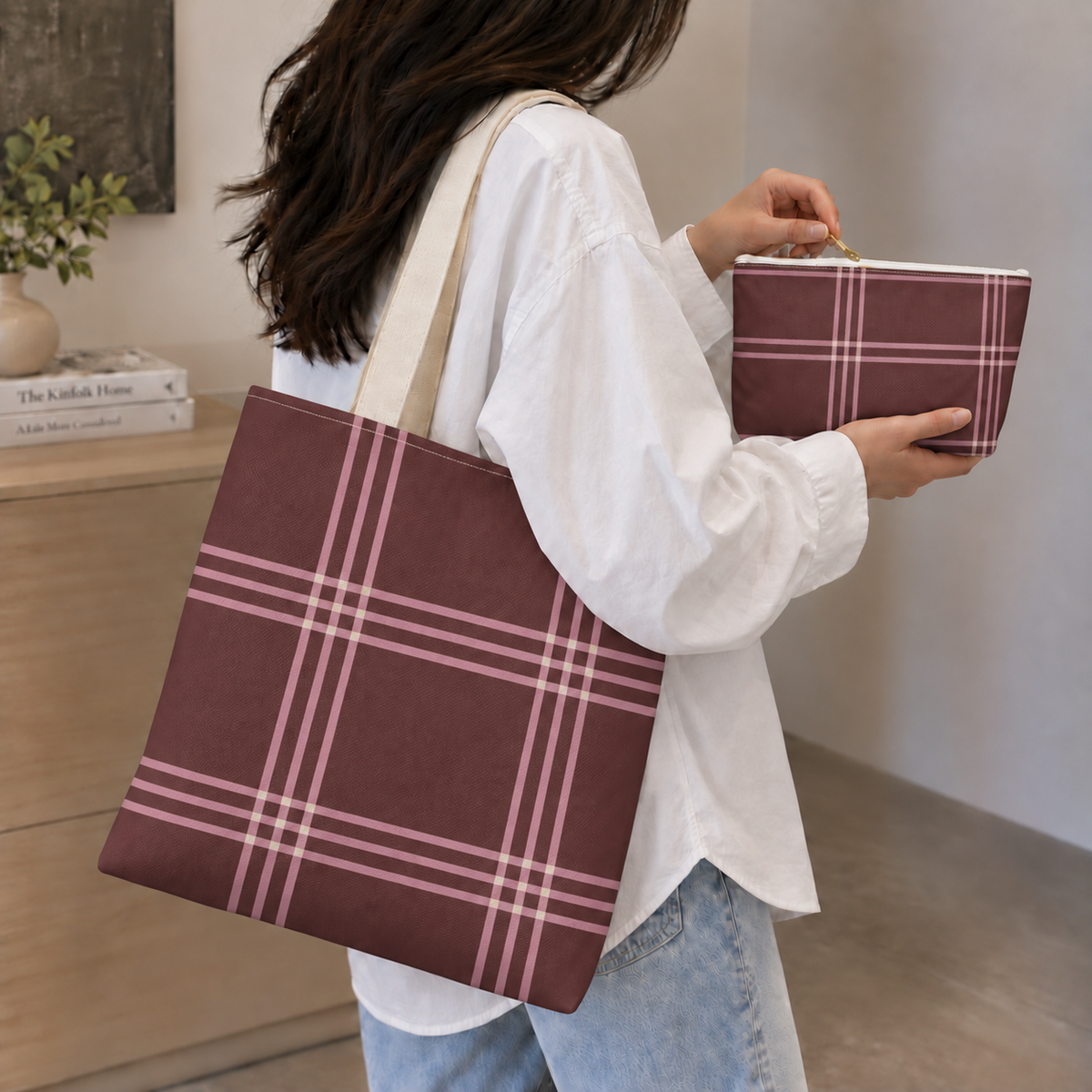 Woman in a white shirt carrying the burgundy pink plaid tote bag with the matching makeup bag