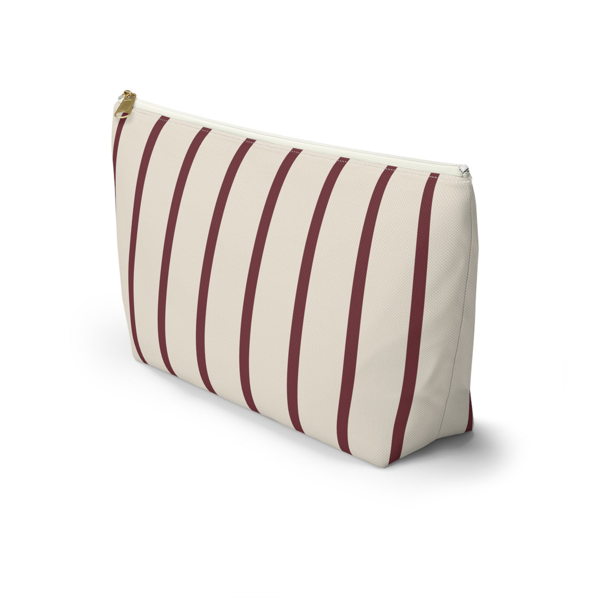 Side view of the burgundy pinstripe makeup bag standing on a white background