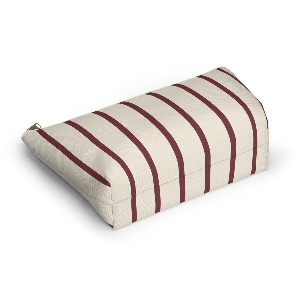 Burgundy pinstripe makeup bag lying on its side showing the thin stripes