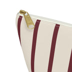 Close-up of the gold zipper pull and burgundy pinstripes on the makeup bag