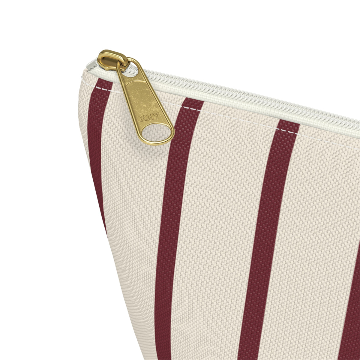 Close-up of the gold zipper pull and burgundy pinstripes on the makeup bag