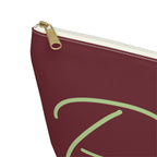 Close-up of the gold zipper pull and green script lettering on the burgundy makeup bag