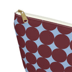 Close-up of the burgundy circle print and gold zipper pull on the makeup bag