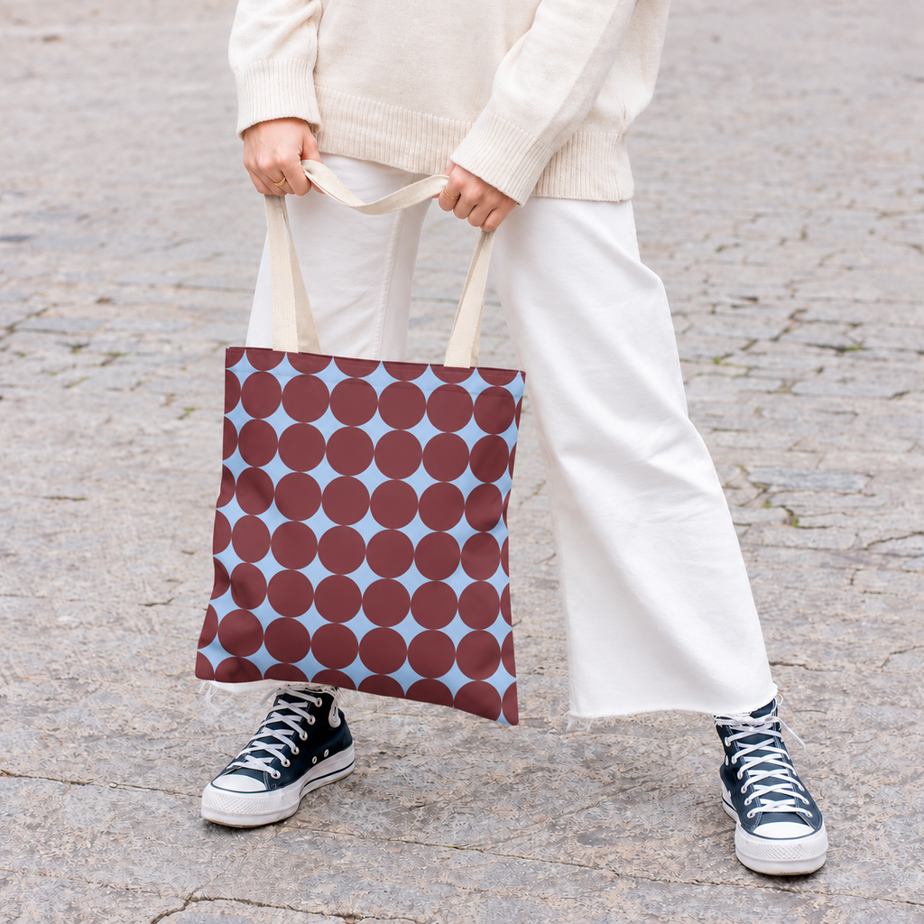 Model in white trousers carrying the retro Burgundy Sky Blue Geometric tote bag