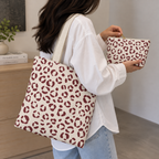 Cream burgundy leopard print tote bag on the shoulder with the matching makeup bag