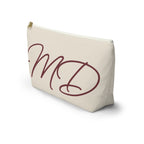 Side view of the cream makeup bag with burgundy script initials