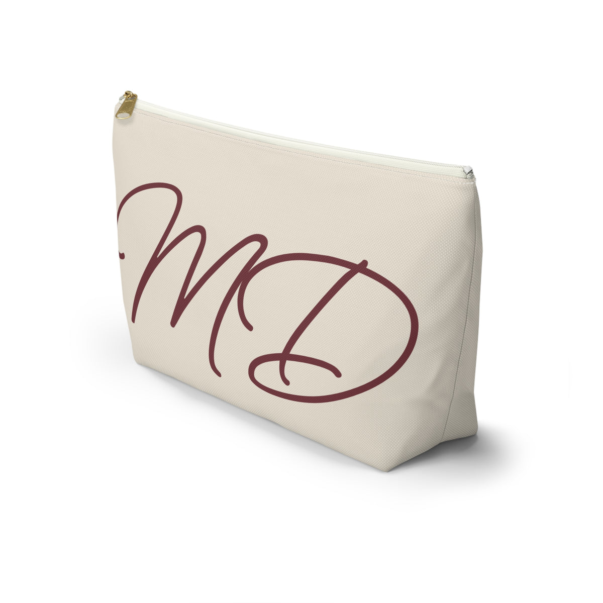 Side view of the cream makeup bag with burgundy script initials