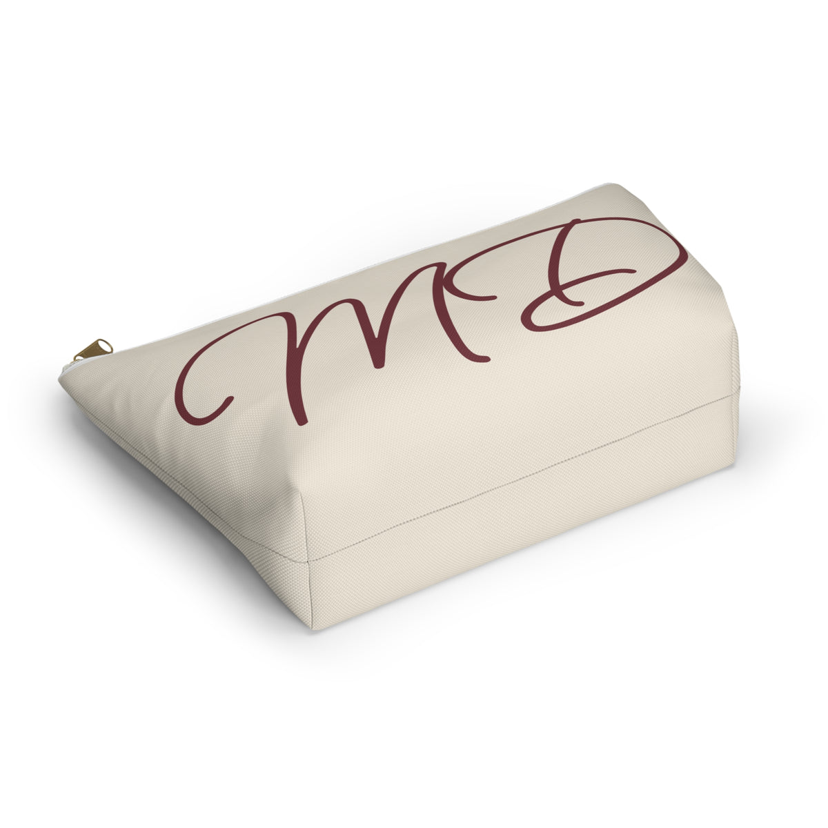 Cream personalized makeup bag lying on its side with burgundy script initials