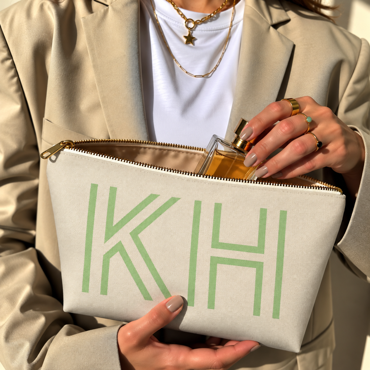Hands holding the open Cream Green Monogram personalized makeup bag