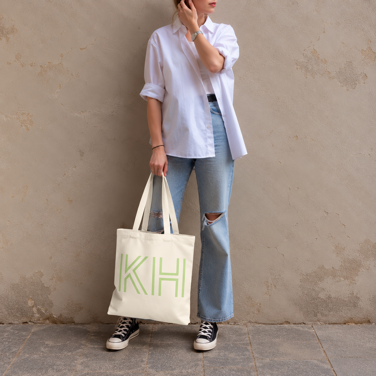 Model standing outdoors with the Cream Green Monogram personalized tote bag in a full-body photo