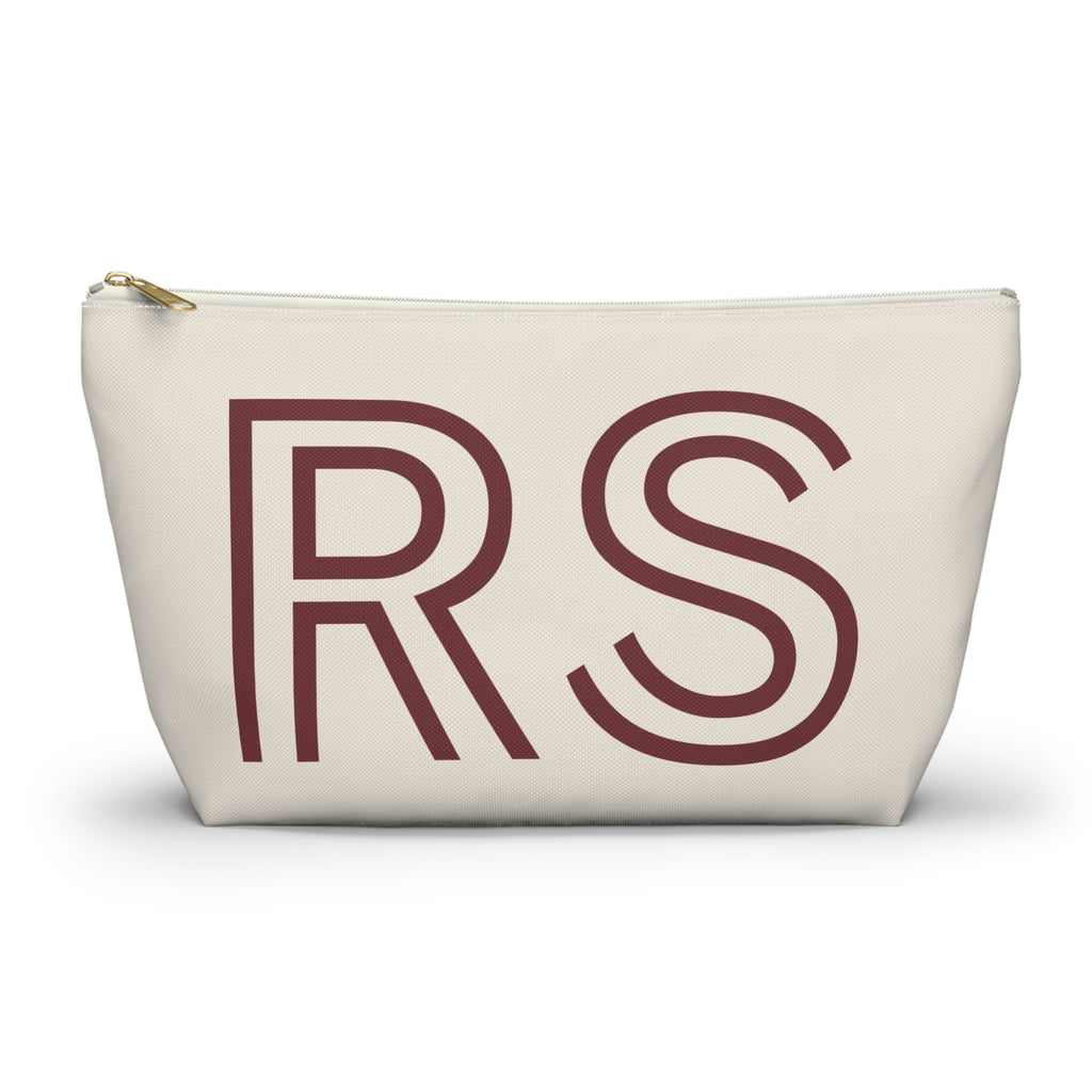 Cream personalized makeup bag with burgundy outlined RS initials and gold zipper pull