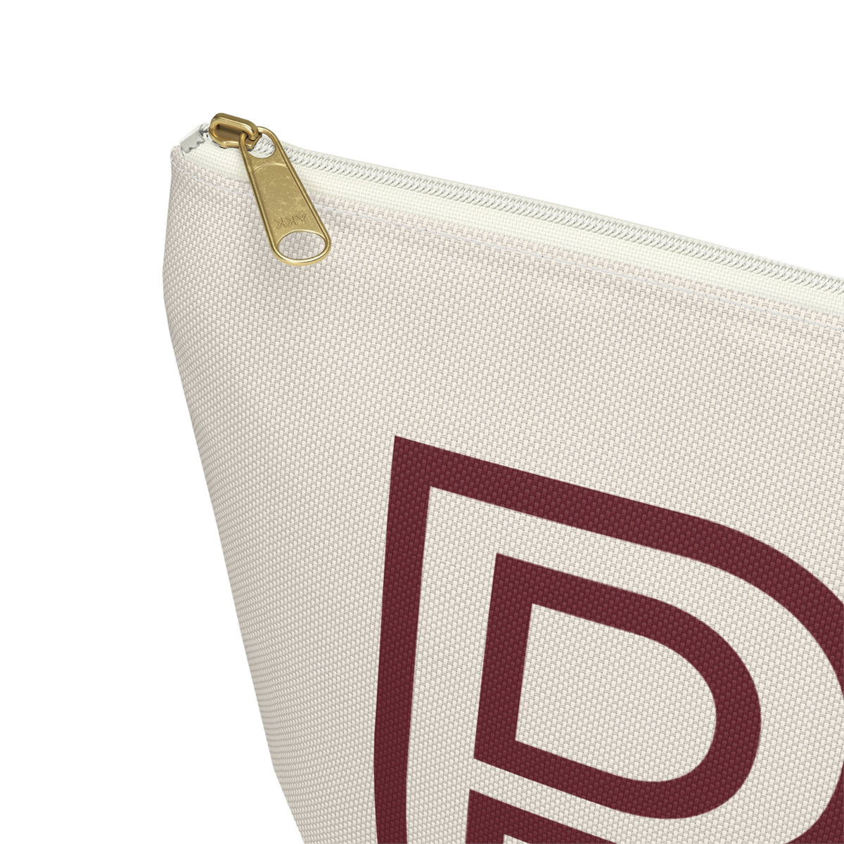 Close-up of the gold zipper pull on the cream personalized makeup bag