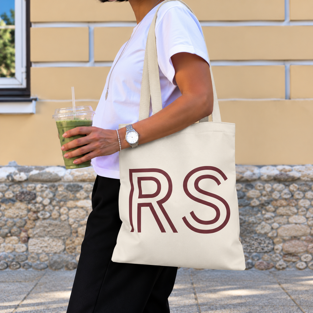 Woman with an iced drink carrying the cream RS monogram personalized tote bag