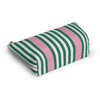 Angled view of the striped makeup bag lying on its side