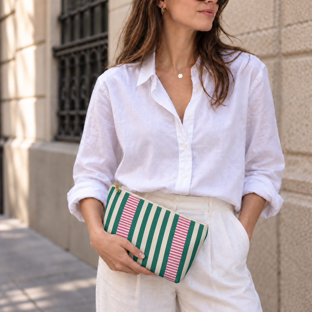 Model holding the Emerald Green Pink Striped makeup bag like a clutch
