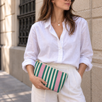 Model holding the Emerald Green Pink Striped makeup bag like a clutch