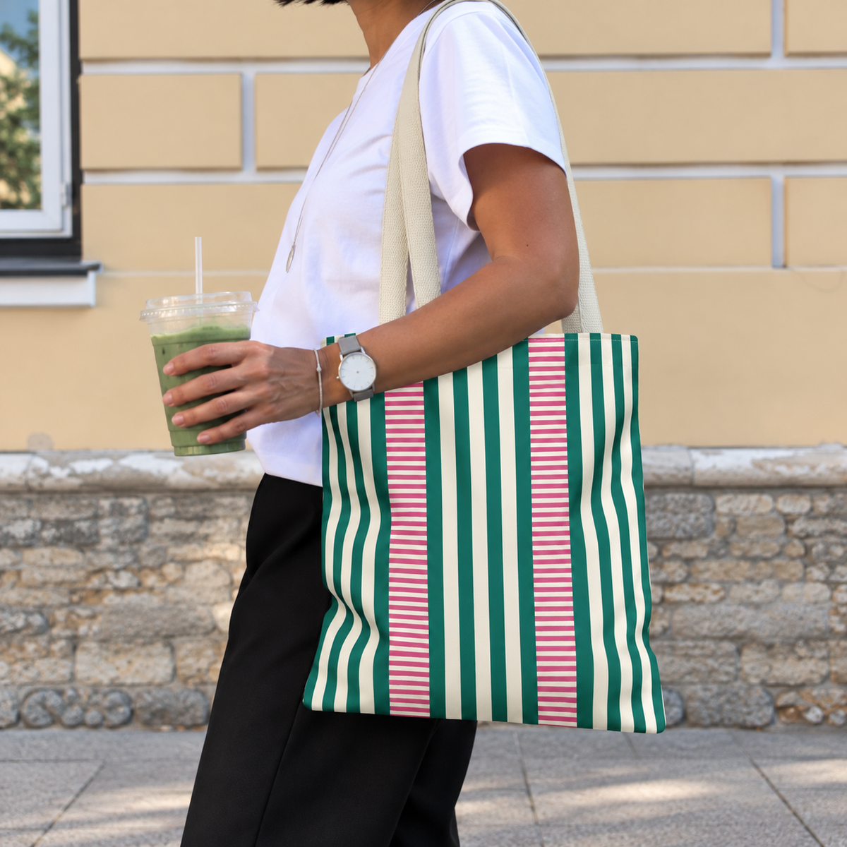 Woman walking with the Emerald Green Pink Striped tote bag on her shoulder