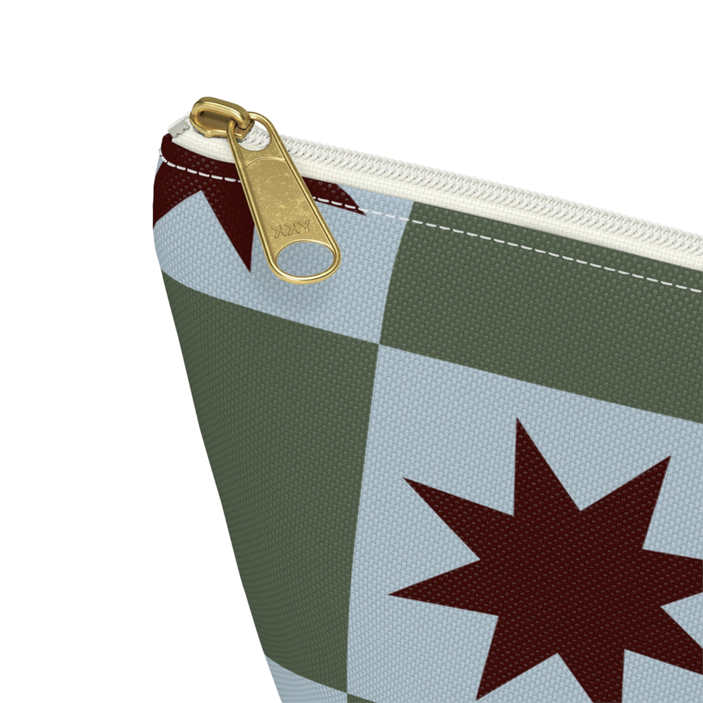 Close-up of the gold zipper pull on the green blue star checkered makeup bag
