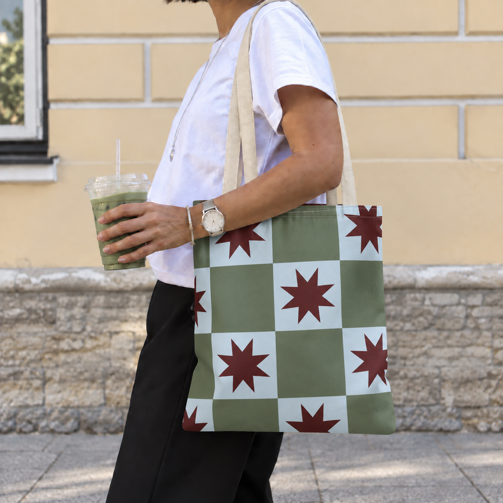 Side view of a model carrying the green blue star checkered tote bag on the shoulder