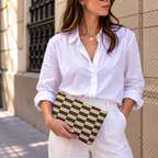 Woman in a white shirt holding the green burgundy checkered makeup bag as a clutch