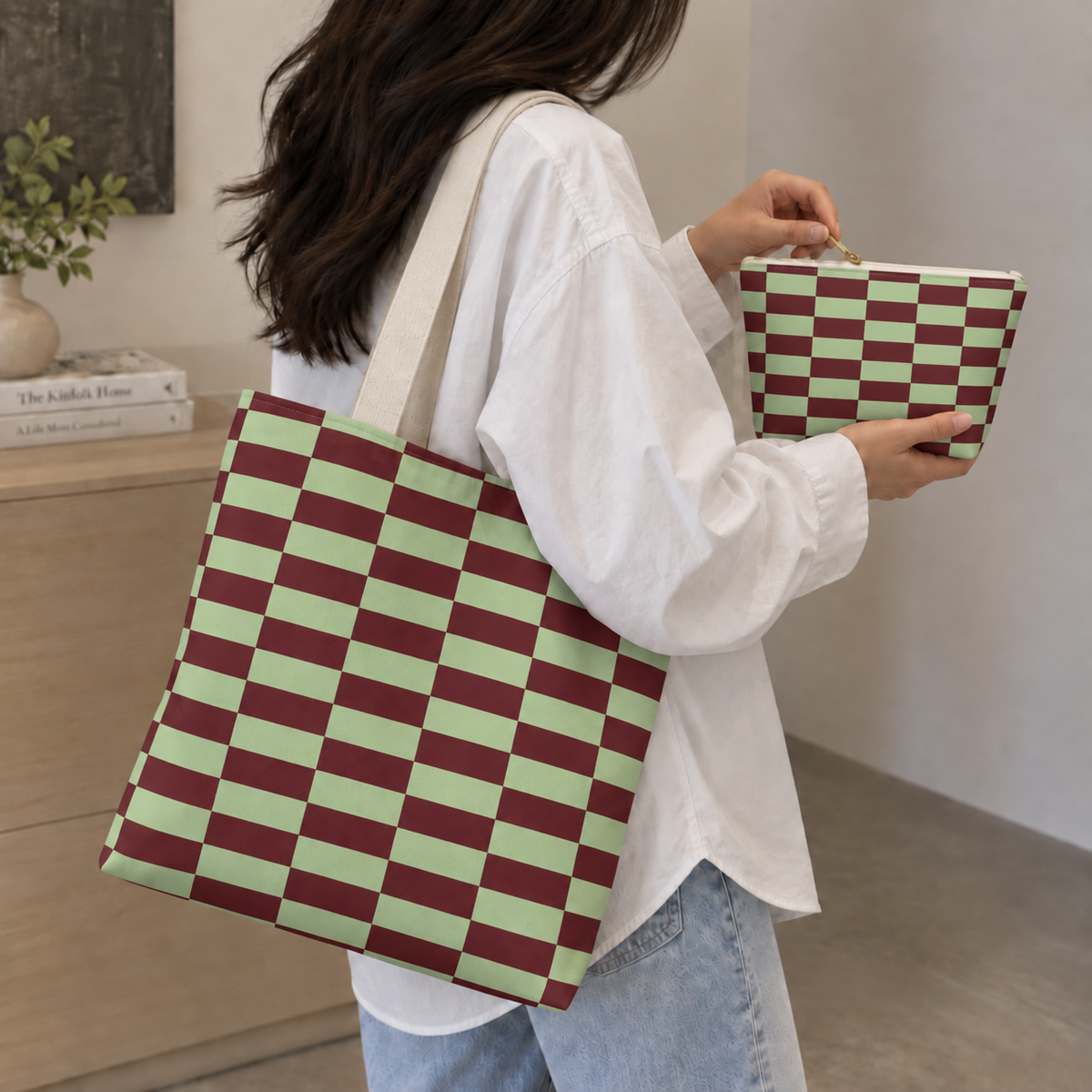 Woman holding the green burgundy checkered tote bag and matching makeup bag