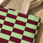 Close-up of the green burgundy checkered print and handle on the tote bag