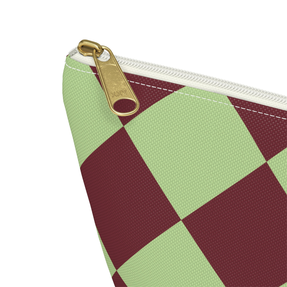 Close-up of the gold zipper pull and sage burgundy diamond checks on the makeup bag