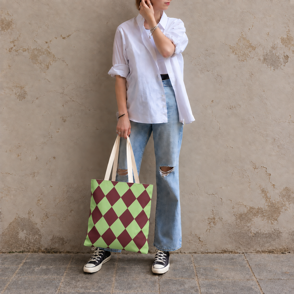 Woman in jeans and sneakers holding the green burgundy diamond checkered tote bag
