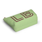 Green burgundy personalized makeup bag lying at an angle on a white background