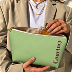 Hands holding the open Green Burgundy Name personalized makeup bag