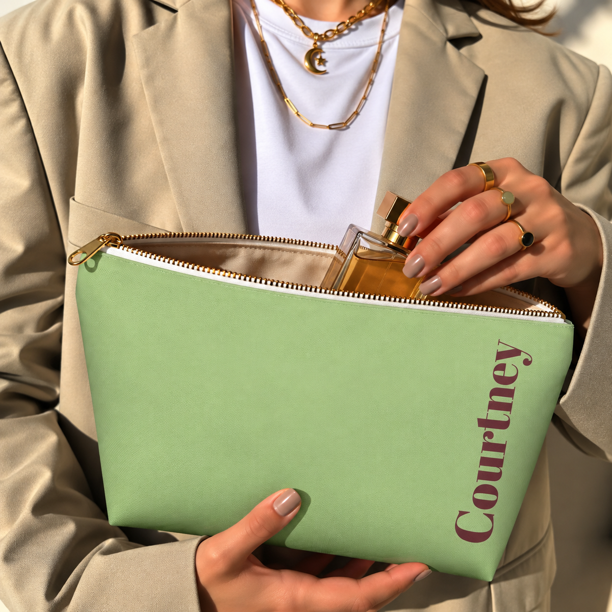 Hands holding the open Green Burgundy Name personalized makeup bag