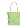 Green burgundy polka dot tote bag with beige handles on a white background
