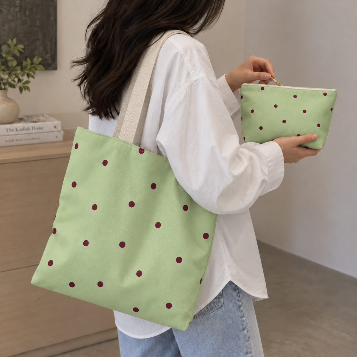 Green burgundy polka dot tote bag on the shoulder with a matching makeup bag in hand