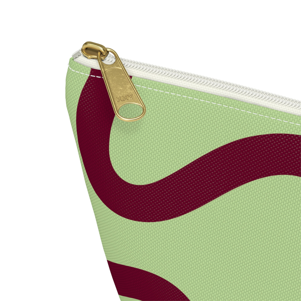 Close-up of the gold zipper pull on the green burgundy wavy line makeup bag