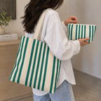 Woman carrying the matching tote bag and Green Cream Striped makeup bag
