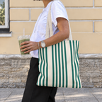 Woman walking with the Green Cream Striped tote bag on her shoulder