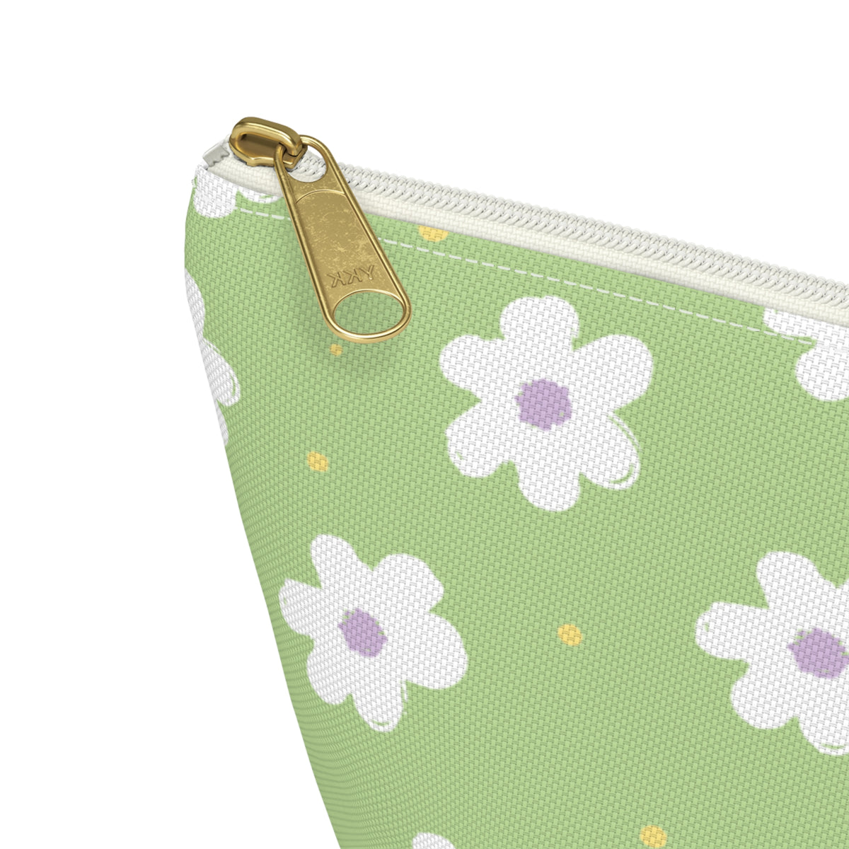 Close-up of the gold zipper pull and white daisy print on the green makeup bag