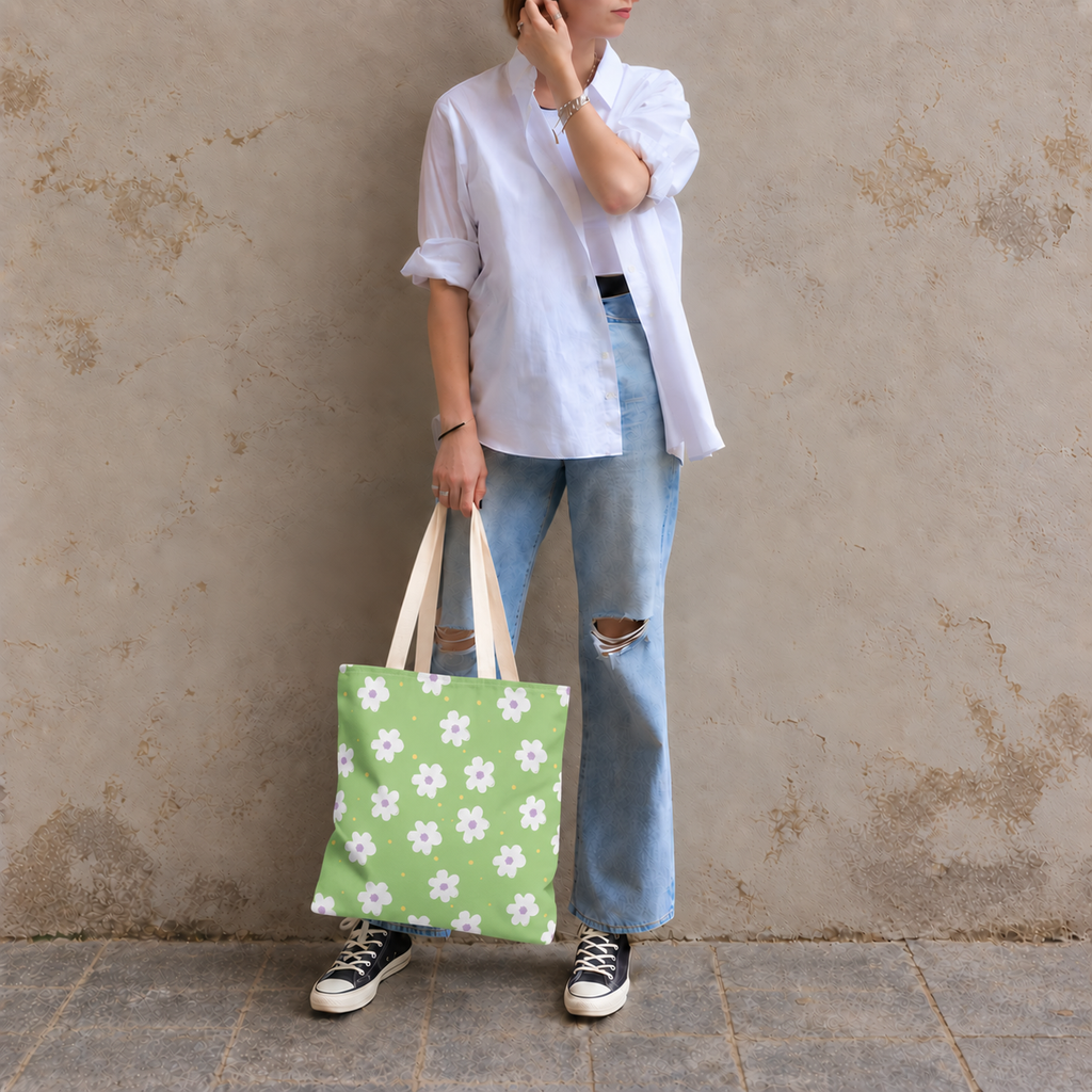Model in jeans standing with the green daisy tote bag in her hand