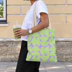 Side view of a model carrying the green lavender half circle tote bag on the shoulder