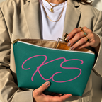 Hands holding the open Green Pink Monogram personalized makeup bag