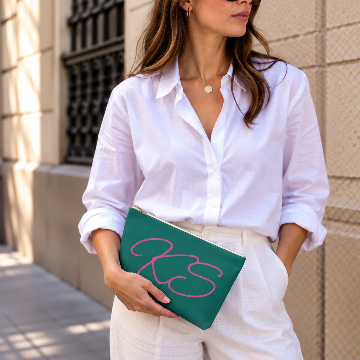 Woman in a white shirt holding the Green Pink Monogram personalized makeup bag