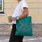 Woman carrying the Green Pink Monogram personalized tote bag, side view with an iced drink