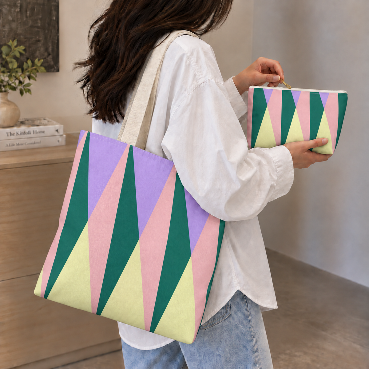 Woman carrying the matching triangle tote bag with the makeup bag in her hand