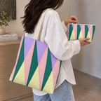 Woman carrying the green pink triangle tote bag with the matching makeup bag