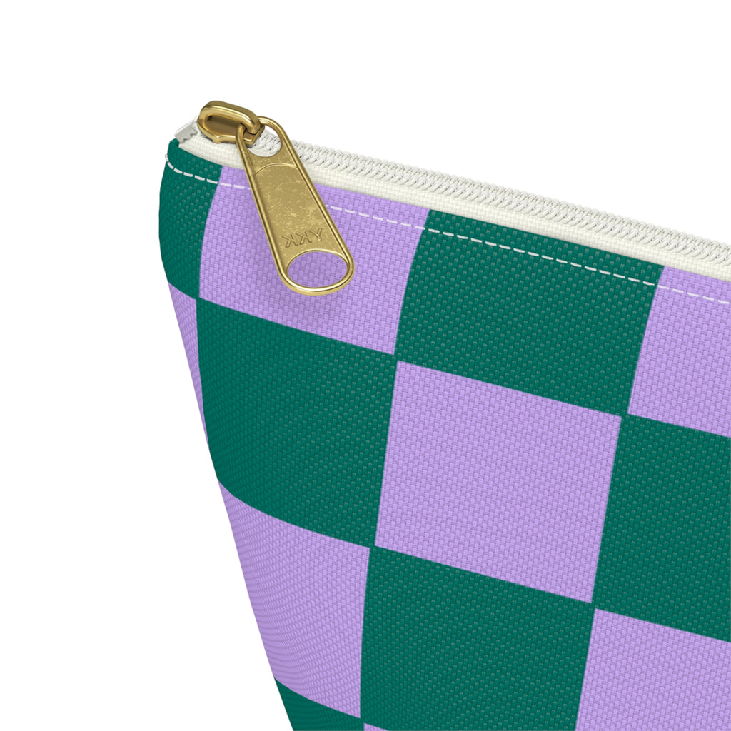 Close-up of the gold zipper pull on the green purple checkered makeup bag