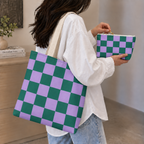 Woman holding the green purple checkered tote bag and matching makeup bag