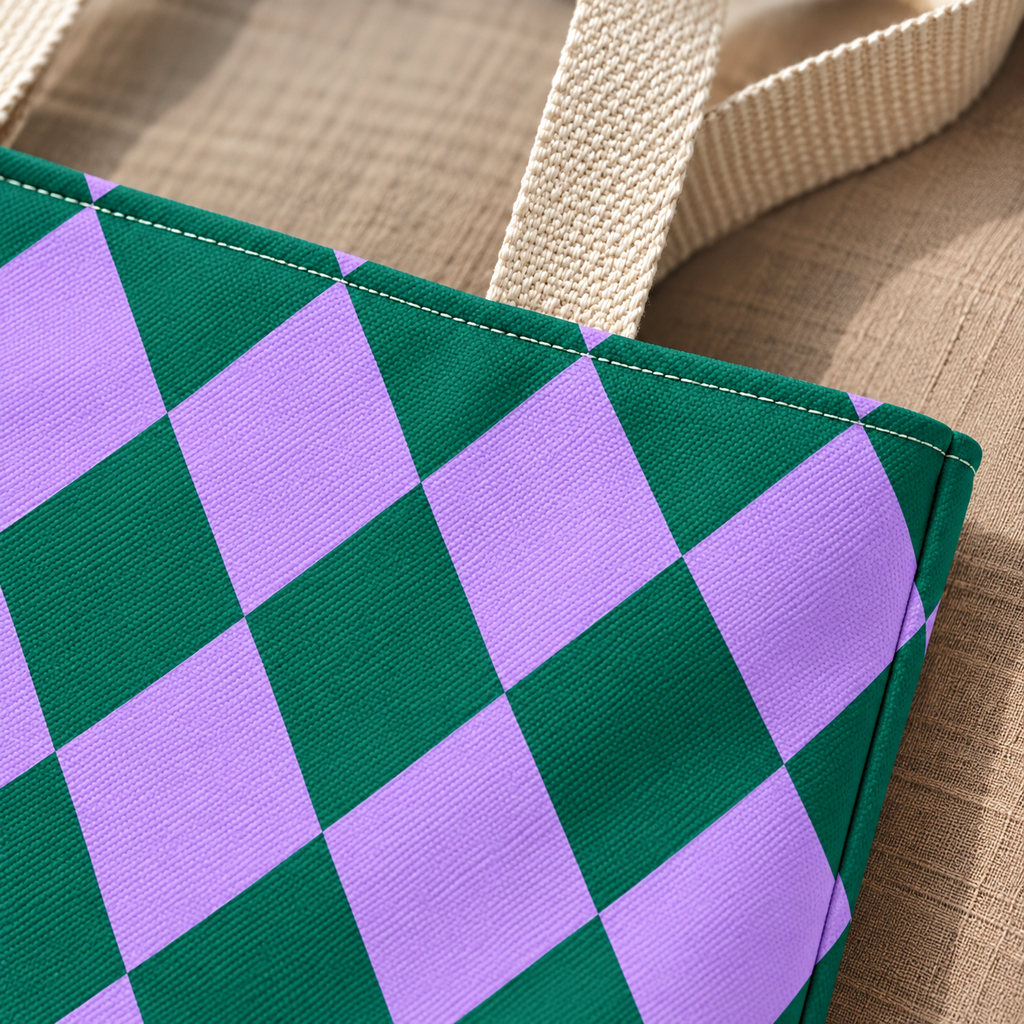 Close-up of emerald green and lilac diamond checks next to the beige tote handle